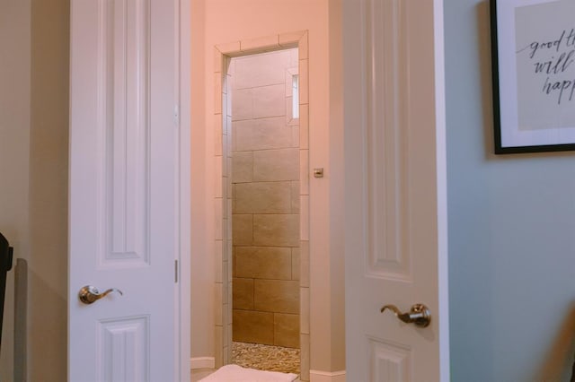 12113 SW 45th Ter, Mustang, OK 73064 - full bathroom featuring a tile shower and baseboards