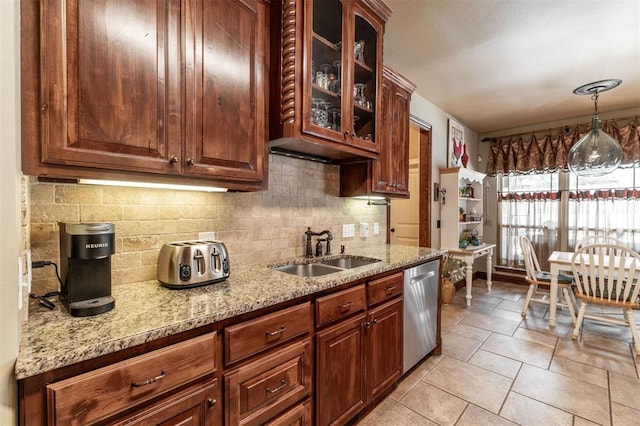 4417 Man O War Dr, Edmond, OK 73025 - kitchen featuring dishwasher, backsplash, light stone countertops, and glass insert cabinets