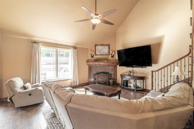 4417 Man O War Dr, Edmond, OK 73025 - living area featuring ceiling fan, wood finished floors, high vaulted ceiling, and a tile fireplace