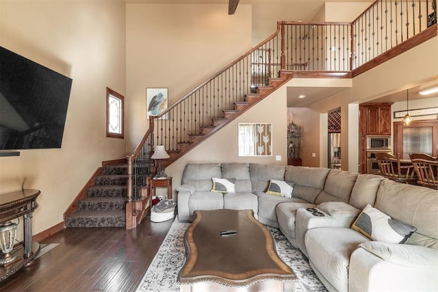 4417 Man O War Dr, Edmond, OK 73025 - living room featuring a high ceiling, stairway, and hardwood / wood-style floors