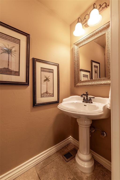 4417 Man O War Dr, Edmond, OK 73025 - bathroom with baseboards and tile patterned flooring