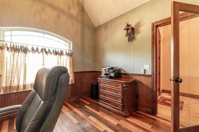 4417 Man O War Dr, Edmond, OK 73025 - home office featuring hardwood / wood-style floors, healthy amount of natural light, vaulted ceiling, a wainscoted wall, and wood walls