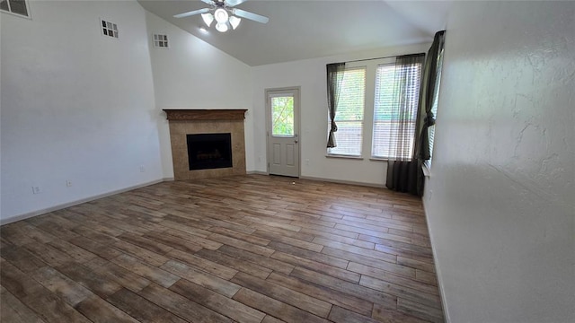 3441 NW 176th St, Edmond, OK 73012 - unfurnished living room with vaulted ceiling, ceiling fan, wood finished floors, and a tile fireplace
