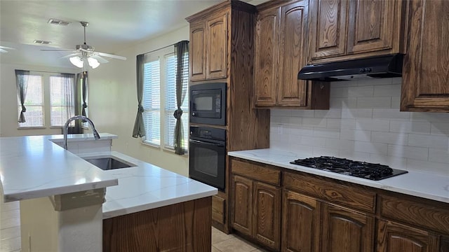 3441 NW 176th St, Edmond, OK 73012 - kitchen featuring black appliances, under cabinet range hood, decorative backsplash, ceiling fan, and a kitchen island with sink