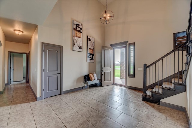 11620 Mallorca Dr, Oklahoma City, OK 73173 - entryway featuring a towering ceiling, stairs, a chandelier, and tile patterned flooring