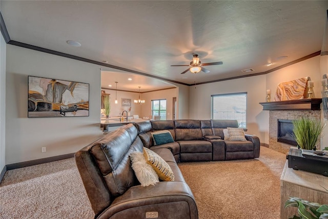 11620 Mallorca Dr, Oklahoma City, OK 73173 - carpeted living area featuring ornamental molding, a ceiling fan, a fireplace, a chandelier, and arched walkways