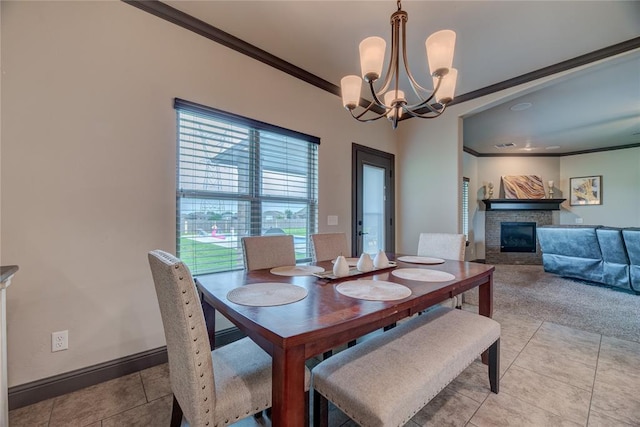 11620 Mallorca Dr, Oklahoma City, OK 73173 - dining space with crown molding, a chandelier, light tile patterned floors, and a stone fireplace