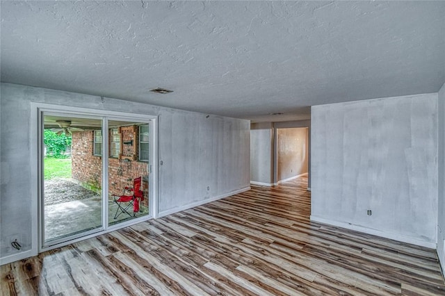 1540 Bradley Pl, Oklahoma City, OK 73127 - spare room featuring wood finished floors and a textured ceiling