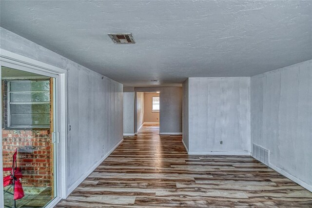 1540 Bradley Pl, Oklahoma City, OK 73127 - empty room with wood finished floors and a textured ceiling