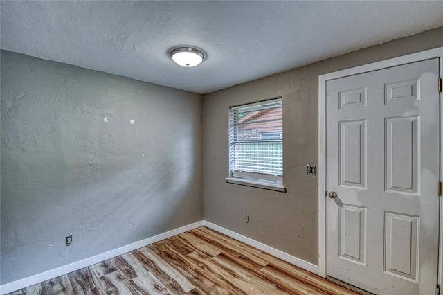 1540 Bradley Pl, Oklahoma City, OK 73127 - spare room featuring light wood-style flooring and a textured ceiling