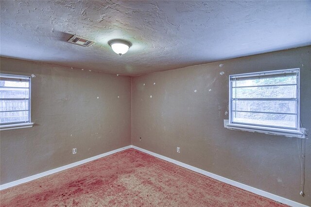 1540 Bradley Pl, Oklahoma City, OK 73127 - carpeted empty room featuring healthy amount of natural light and a textured ceiling