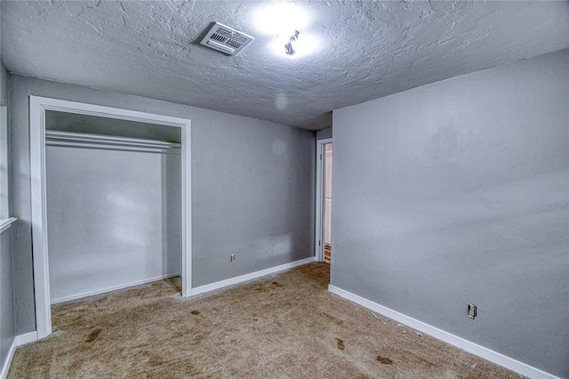 1540 Bradley Pl, Oklahoma City, OK 73127 - unfurnished bedroom with carpet flooring, a textured ceiling, and a closet