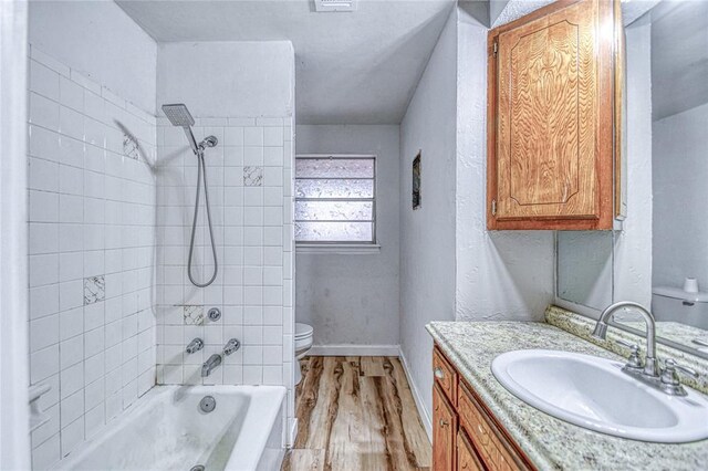1540 Bradley Pl, Oklahoma City, OK 73127 - bathroom featuring vanity, wood finished floors, and washtub / shower combination