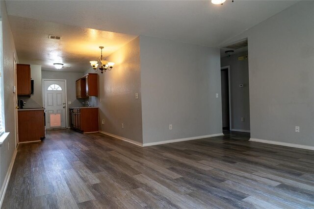 1001 Hyacinth Hollow Dr, Yukon, OK 73099 - unfurnished living room featuring a chandelier and dark wood-style floors