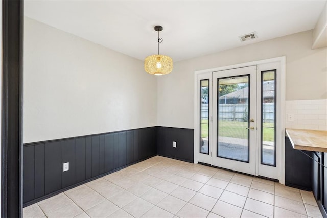 2309 Morning Glory Dr, Oklahoma City, OK 73159 - unfurnished dining area with wainscoting and light tile patterned floors