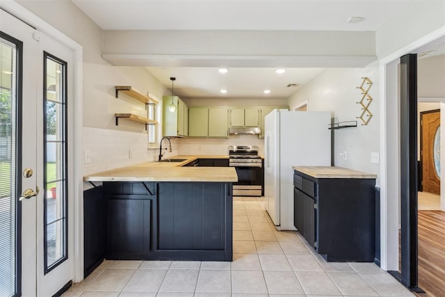 2309 Morning Glory Dr, Oklahoma City, OK 73159 - kitchen with gas range, freestanding refrigerator, a peninsula, backsplash, and recessed lighting