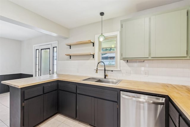 2309 Morning Glory Dr, Oklahoma City, OK 73159 - kitchen with stainless steel dishwasher, wood counters, a peninsula, and backsplash