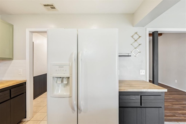 2309 Morning Glory Dr, Oklahoma City, OK 73159 - kitchen with white refrigerator with ice dispenser, wooden counters, backsplash, and light wood-style flooring
