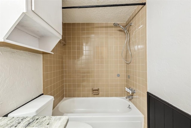 2309 Morning Glory Dr, Oklahoma City, OK 73159 - bathroom featuring shower / washtub combination, wainscoting, and a textured ceiling