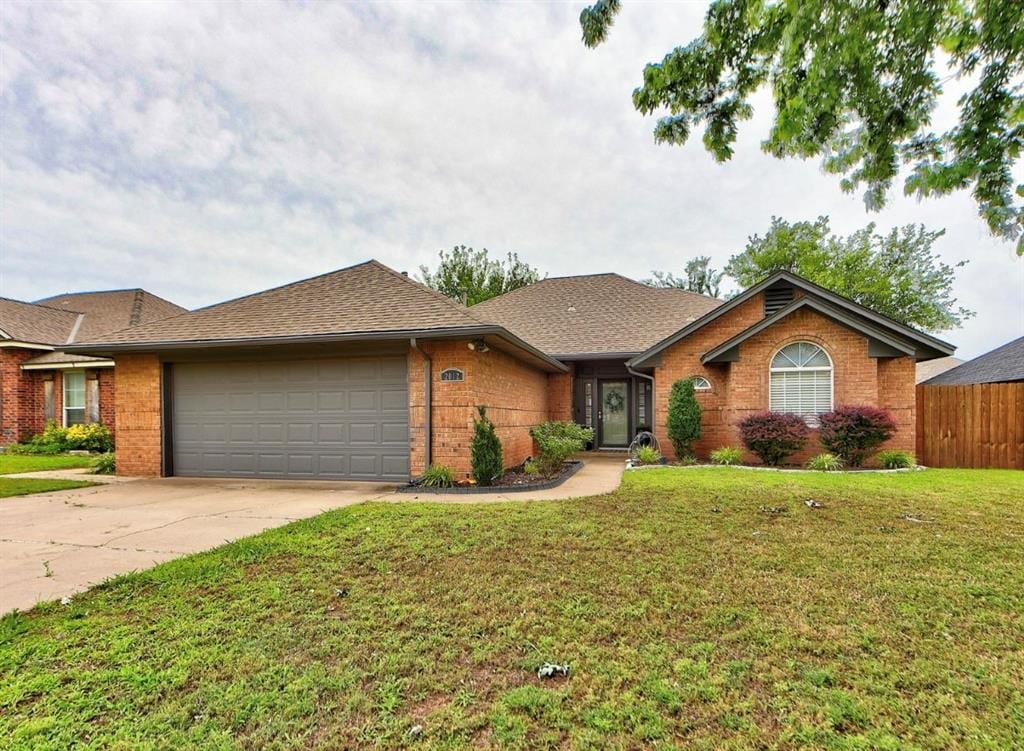 2012 Sagewood Dr, Edmond, OK 73013 - single story home featuring a garage, brick siding, concrete driveway, and roof with shingles