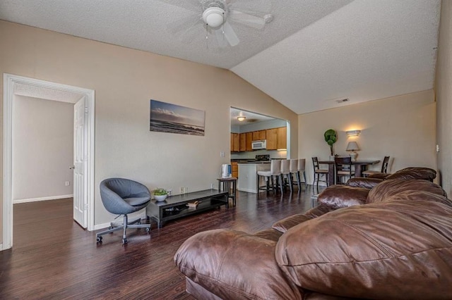 2200 Classen Blvd Unit 2131, Norman, OK 73107 - living room with a ceiling fan, wood finished floors, vaulted ceiling, and a textured ceiling