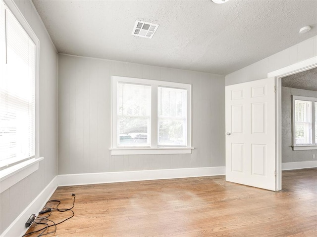 1527 NW 43rd St, Oklahoma City, OK 73118 - unfurnished bedroom featuring light wood-style floors and a textured ceiling