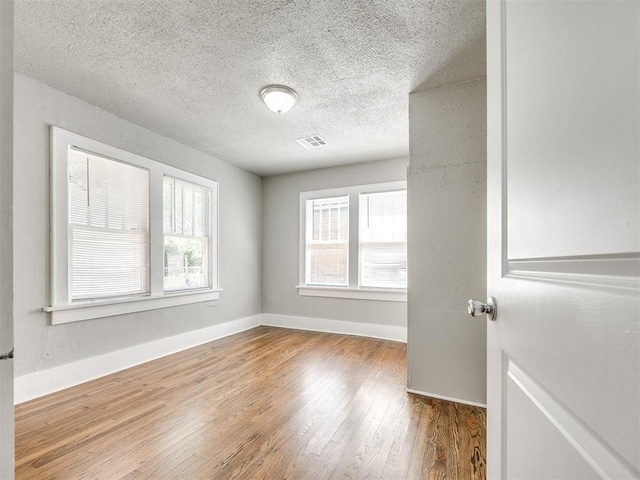 1527 NW 43rd St, Oklahoma City, OK 73118 - empty room with wood finished floors and a textured ceiling
