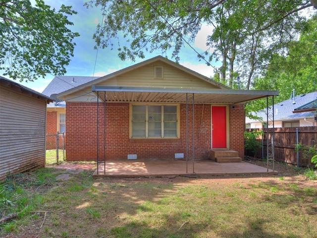 1527 NW 43rd St, Oklahoma City, OK 73118 - back of property with entry steps, a patio area, brick siding, and crawl space