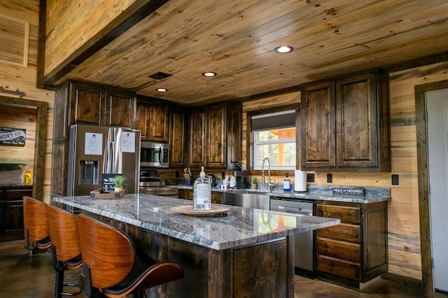 17 Honor Ct, Broken Bow, OK 74728 - kitchen with appliances with stainless steel finishes, wooden ceiling, light stone countertops, wood walls, and dark brown cabinetry