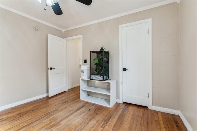 300 S Davidson Rd, Midwest City, OK 73130 - unfurnished bedroom with light wood finished floors, ornamental molding, and a ceiling fan