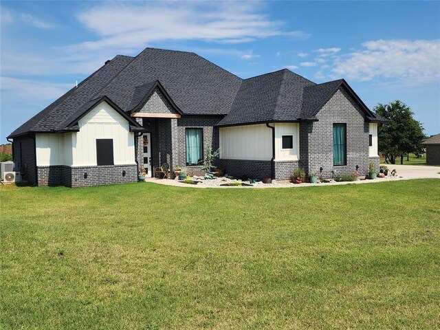 26784 Stirrup Ct, Blanchard, OK 73010 - french country inspired facade featuring brick siding, board and batten siding, a front lawn, and a shingled roof