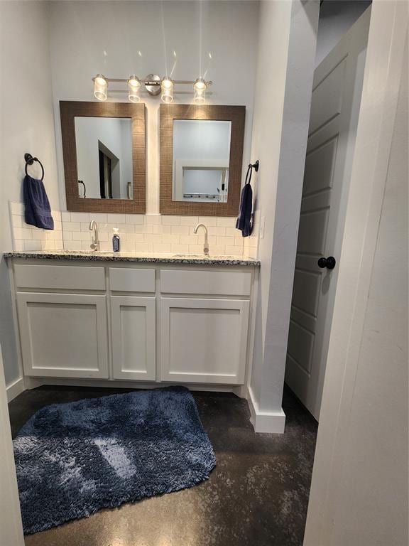 26784 Stirrup Ct, Blanchard, OK 73010 - full bath with double vanity, finished concrete floors, and decorative backsplash
