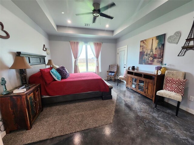 26784 Stirrup Ct, Blanchard, OK 73010 - bedroom featuring finished concrete floors, a tray ceiling, and ceiling fan