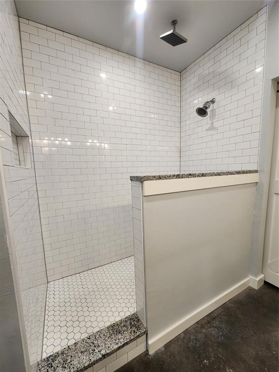 26784 Stirrup Ct, Blanchard, OK 73010 - bathroom with a walk in shower and concrete flooring