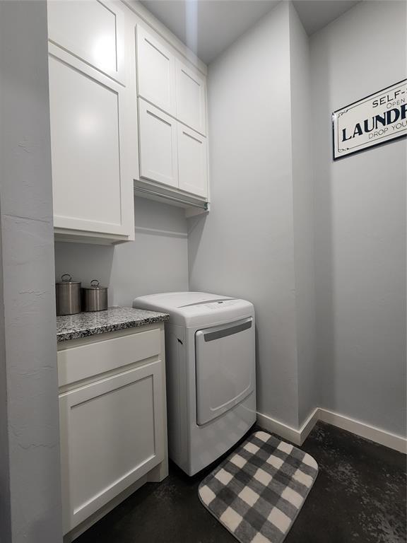 26784 Stirrup Ct, Blanchard, OK 73010 - laundry area with cabinet space and baseboards