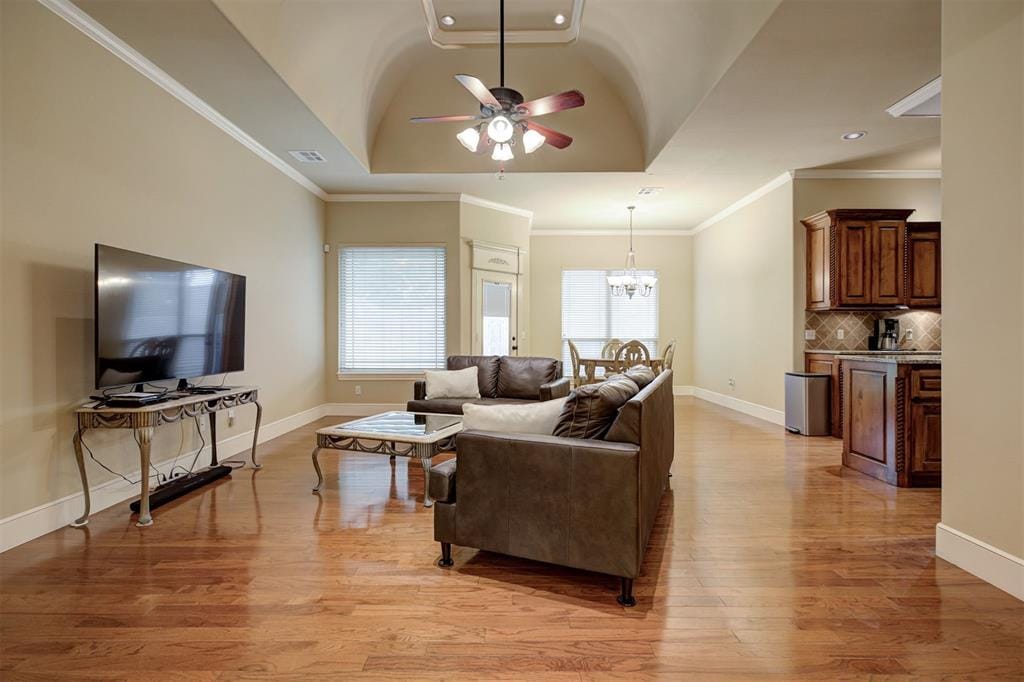 604 Eastmoor Ct, Moore, OK 73160 - living room with light wood finished floors, a ceiling fan, recessed lighting, a chandelier, and ornamental molding