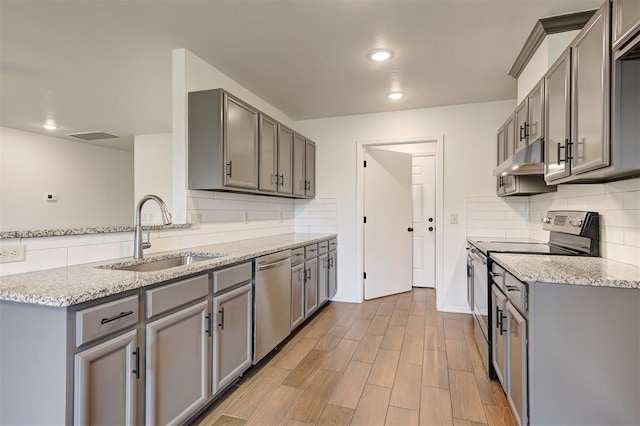 11116 SW 37th St, Mustang, OK 73064 - kitchen with stainless steel appliances, gray cabinets, backsplash, light stone countertops, and recessed lighting
