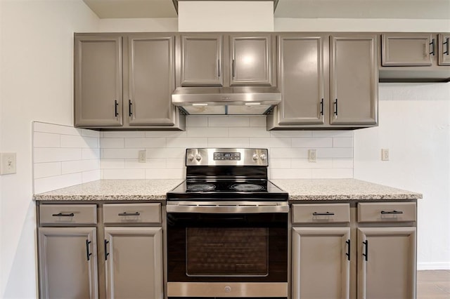 11116 SW 37th St, Mustang, OK 73064 - kitchen with under cabinet range hood, electric stove, gray cabinets, and tasteful backsplash