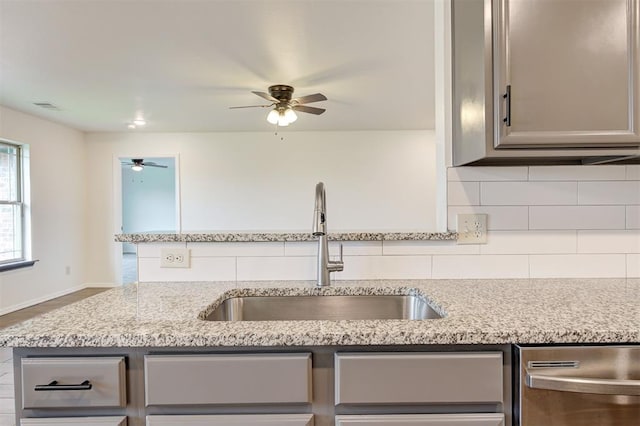 11116 SW 37th St, Mustang, OK 73064 - kitchen with a ceiling fan, backsplash, gray cabinets, dishwasher, and light stone counters