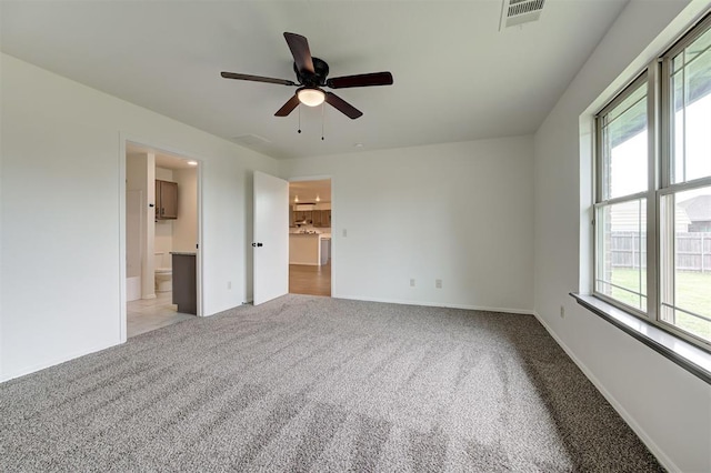 11116 SW 37th St, Mustang, OK 73064 - unfurnished bedroom with multiple windows, light colored carpet, and ceiling fan