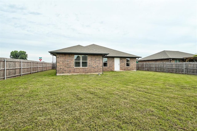 11116 SW 37th St, Mustang, OK 73064 - rear view of property with brick siding, a fenced backyard, and a shingled roof