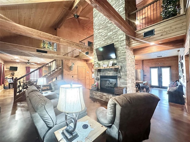 17701 S Rock Creek Rd, Shawnee, OK 74801 - living room with ceiling fan, high vaulted ceiling, wood walls, stairs, and a fireplace
