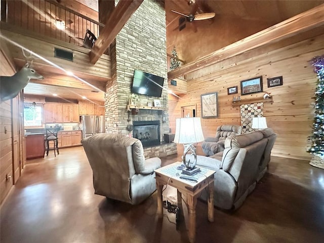 17701 S Rock Creek Rd, Shawnee, OK 74801 - living room with high vaulted ceiling, a fireplace, wooden walls, ceiling fan, and beam ceiling