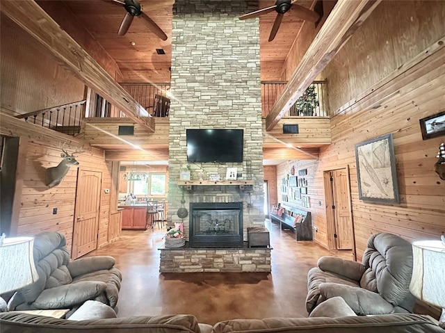 17701 S Rock Creek Rd, Shawnee, OK 74801 - living room with high vaulted ceiling, a ceiling fan, wooden walls, a fireplace, and wooden ceiling