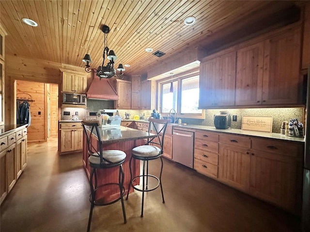 17701 S Rock Creek Rd, Shawnee, OK 74801 - kitchen featuring appliances with stainless steel finishes, finished concrete floors, decorative backsplash, a center island, and recessed lighting