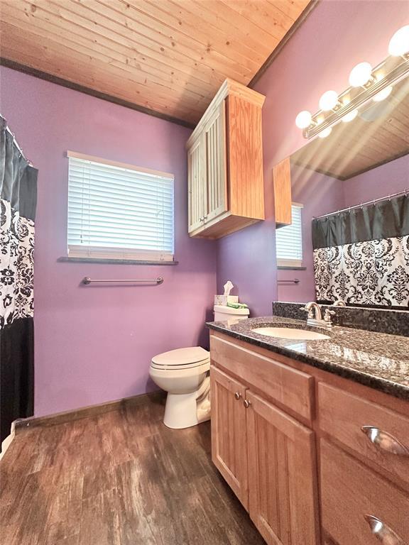 17701 S Rock Creek Rd, Shawnee, OK 74801 - bathroom featuring vanity, wood ceiling, wood finished floors, and a shower with curtain