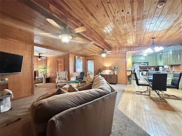 17701 S Rock Creek Rd, Shawnee, OK 74801 - living area with wooden ceiling, light carpet, wooden walls, a ceiling fan, and light wood-style flooring