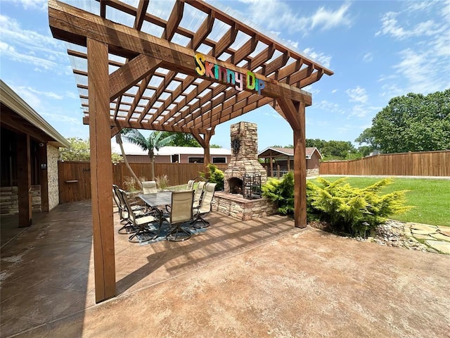 17701 S Rock Creek Rd, Shawnee, OK 74801 - fenced backyard featuring an outdoor stone fireplace, a patio area, a pergola, and outdoor dining area