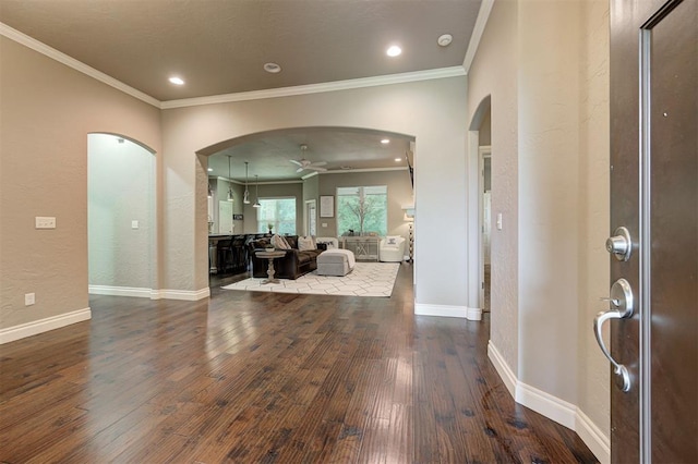 2473 Vellano Ln, Edmond, OK 73034 - entrance foyer featuring arched walkways, dark wood-type flooring, a ceiling fan, ornamental molding, and a textured wall