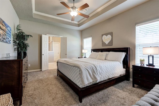 2473 Vellano Ln, Edmond, OK 73034 - carpeted bedroom featuring a tray ceiling, crown molding, a ceiling fan, and connected bathroom